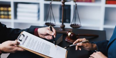 lawyer-working-with-client-discussing-contract-pap-4VLQT2Q